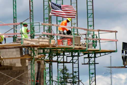 In this June 11, 2020 file photo, workers on scaffolding lay blocks on one of the larger buildings at a development site where various residential units and commercial sites are under construction in Cranberry Township, Butler County, PA