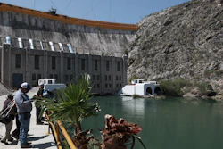 Farmers stand at La Boquilla Dam, where they wrested control on Tuesday from National Guard troops in order to close the valves and reduce the flow of water toward the United States, in Chihuahua State, Wednesday, Sept. 9.