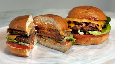 In this May 3, 2019 file photo, an Original Impossible Burger, left, and a Cali Burger, from Umami Burger, are shown in this photo in New York.