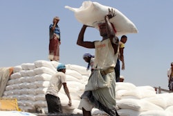 In this Sept. 21, 2018 file photo, men deliver U.N. World Food Programme aid in Aslam, Hajjah, Yemen.