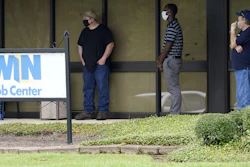 Clients line up outside the Mississippi Department of Employment Security WIN Job Center in Pearl, Miss., Aug. 31, 2020.