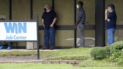 Clients line up outside the Mississippi Department of Employment Security WIN Job Center in Pearl, Miss., Aug. 31, 2020.