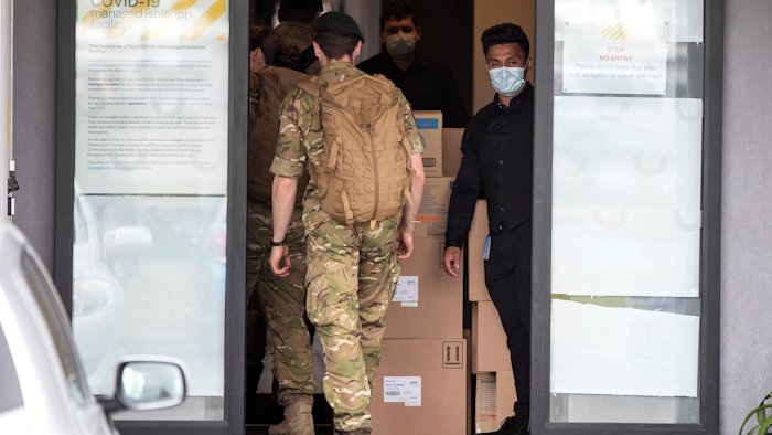 Military personnel enter the Sudima Hotel in Christchurch, New Zealand on Tuesday, Oct. 20.