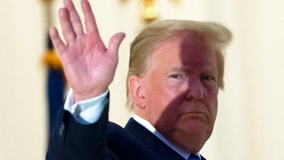 President Donald Trump waves.