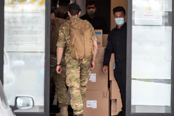 Military personnel enter the Sudima Hotel in Christchurch, New Zealand on Tuesday, Oct. 20.