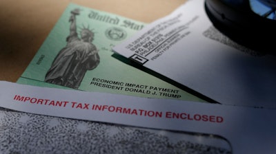 In this April 23 file photo, President Donald Trump's name is seen on a stimulus check issued by the IRS to help combat the adverse economic effects of the COVID-19 outbreak, in San Antonio.