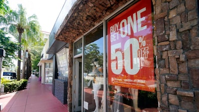 A business displays a 'Buy One Get One 50% Off,' sign Monday, Oct. 12, 2020, in Surfside, Fla. U.S. consumer prices rose slightly in September, led again by sharp increases in the index for used vehicles. The Labor Department reported Tuesday, Oct. 13 that the consumer price index rose 0.2% last month.