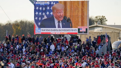 A throng of supporters listen to a video message as they await President Donald Trump for a campaign stop, Saturday, Oct. 31 at the Butler County Regional Airport in Butler, PA.