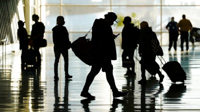 Passengers walk through Salt Lake City International Airport.