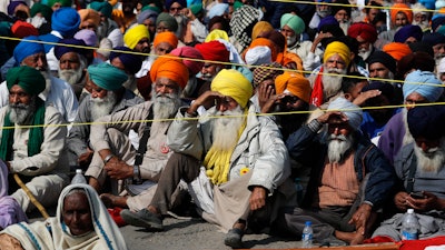 Indian farmers hold a meeting at the Delhi-Haryana state border in India on Sunday, Nov. 29.