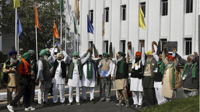 Representatives of various farmers organizations hold hands before the media as they arrive for talks with the government representatives in New Delhi, India on Thursday, Dec. 3.