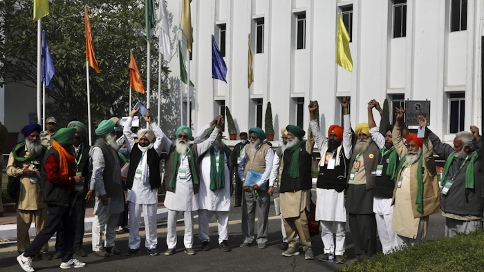Representatives of various farmers organizations hold hands before the media as they arrive for talks with the government representatives in New Delhi, India on Thursday, Dec. 3.