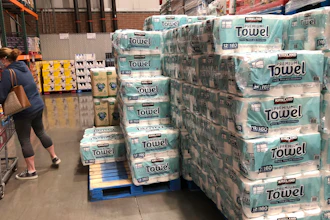 A shopper loads her basket next to a display of paper towels in a Costco warehouse in this photograph taken on Nov. 18 in Sheridan, CO.
