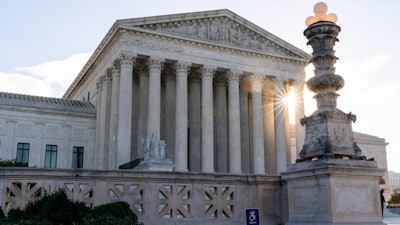 In this Nov. 10 photo, the sun rises behind the U.S. Supreme Court in Washington.