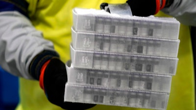 Boxes containing the Pfizer-BioNTech COVID-19 vaccine are prepared to be shipped at the Pfizer Global Supply Kalamazoo manufacturing plant in Portage, Mich., Sunday, Dec. 13, 2020.