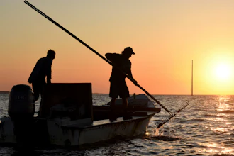 In this May 25, 2016 photo, the work day begins early for oyster harvesters in the Florida panhandle's Apalachicola Bay.