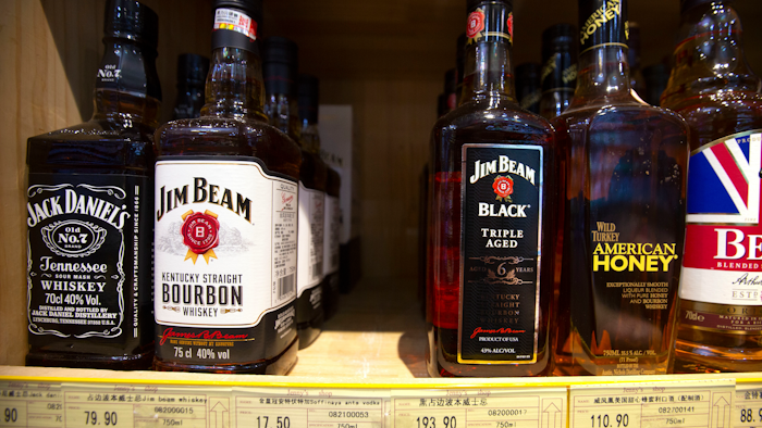 In this July 7, 2018 file photo, whiskeys distilled and bottled in the U.S. are displayed for sale in a grocery store in Beijing.