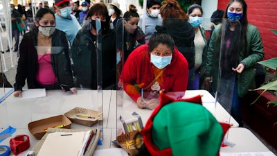 People check in at a food bank held at Los Angeles Boys & Girls Club, Lincoln Heights, Los Angeles, Dec. 17, 2020.