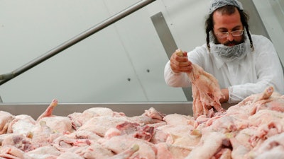 An Orthodox rabbi is checking the quality of poultry meat in a Kosher slaughterhouse in Csengele, Hungary on Jan. 15.