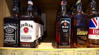 In this July 7, 2018 file photo, whiskeys distilled and bottled in the U.S. are displayed for sale in a grocery store in Beijing.
