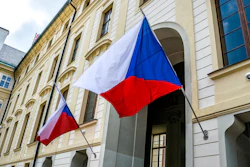 State flags of the Czech Republic on the facade of a government building in Prague.