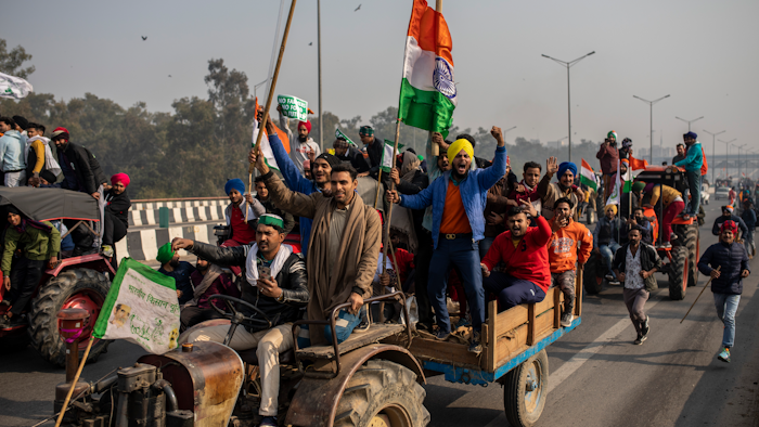 In this Jan. 26 photo, protesting farmers ride tractors and shout slogans as they march to the capital breaking police barricades during India's Republic Day celebrations in New Delhi, India.