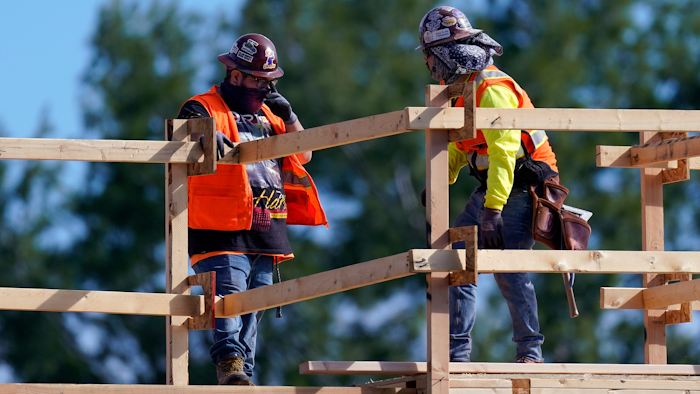 Construction workers talk at a USA Properties Fund site in Simi Valley, California. Hiring has weakened for six straight months.