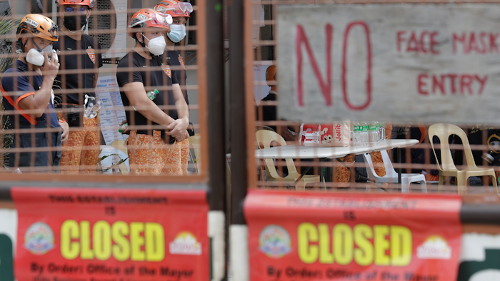 Rescuers stand inside the compound of the TP Marcelo Ice Plant in Navotas, Philippines. An ammonia leak from the ice plant in the Philippine capital region left some dead and more than 90 injured or sickened.