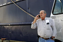 In this Oct. 14, 2014 file photo, Carlos Rafael talks on the phone at Homer's Wharf near his herring boat F/V Voyager in New Bedford, MA.