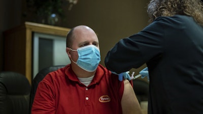 In this Feb. 2 photo, Tyson Foods team members receive Covid-19 vaccines from health officials at the Wilkesboro, NC facility.