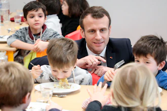 In this Jan.18, 2019 file photo, French President Emmanuel Macron meets pupils as he visits a school canteen in Saint-Sozy, southwestern France.