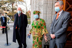 New Director-General of the World Trade Organisation Ngozi Okonjo-Iweala, center, speaks between WTO Deputy Directors-General Alan Wolff, left, and Karl Brauner upon her arrival at the WTO headquarters to takes office in Geneva, Switzerland on Monday, March 1.