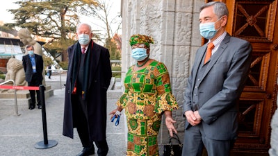 New Director-General of the World Trade Organisation Ngozi Okonjo-Iweala, center, speaks between WTO Deputy Directors-General Alan Wolff, left, and Karl Brauner upon her arrival at the WTO headquarters to takes office in Geneva, Switzerland on Monday, March 1.