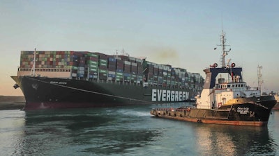 In this photo released by Suez Canal Authority, the Ever Given, a Panama-flagged cargo ship, is pulled by one of the Suez Canal tugboats, in the Suez Canal, Egypt on Monday, March 29.