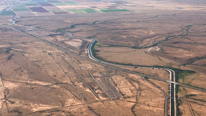 In this Oct. 8, 2019 photo, the Central Arizona Project canal runs through rural desert near Phoenix.