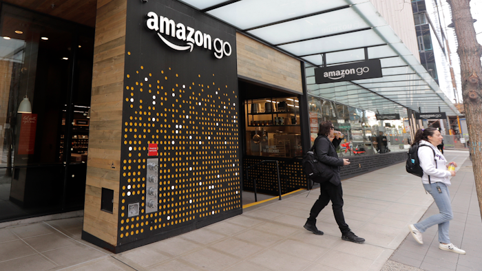 In this file photo, people walk out of an Amazon Go store, in Seattle.