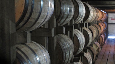 In this July 24, 2014 file photo, bourbon supplies age in barrels at the Jim Beam distillery in Clermont, Ky.