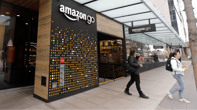In this file photo, people walk out of an Amazon Go store, in Seattle.