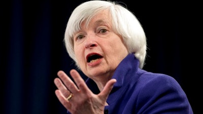 In this Dec. 13, 2017 file photo, Federal Reserve Chair Janet Yellen speaks during a news conference following the Federal Open Market Committee meeting in Washington. Yellen on Monday, April 5, 2021, urged the adoption of a minimum global corporate income tax, an effort to offset any disadvantages that might arise from the Biden administration’s proposed increase in the U.S. corporate tax rate.