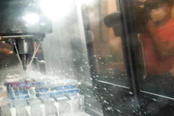 A videographer captures a CNC (computer numerical control) machine at work before a ribbon-cutting ceremony to mark the opening of a Nanotronics manufacturing center at the Brooklyn Navy Yard on April 28 in the Brooklyn borough of New York.