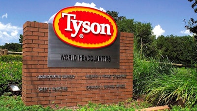 In this July 30, 2001, file photo, a sign marks the entrance to Tyson Foods headquarters in Springdale, Ark. Tyson Foods says it is raising wages to combat absenteeism and worker turnover at its plants as U.S. demand for chicken soars. The Springdale, Arkansas-based company said Monday, May 10, 2021, that absentee rates are around 50% higher than they were before the pandemic.