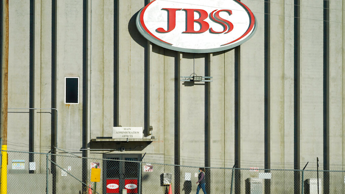 In this Oct. 12, 2020 photo, a worker heads into the JBS meatpacking plant in Greeley, Colo.