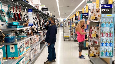 Consumers shop as they wear a mask at a Walmart store in Vernon Hills, IL on May 23.