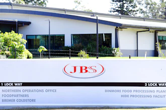 In this May 12, 2020 photo, the company logo sign sits at the entrance to the JBS Australia's Dinmore meatworks facility, west of Brisbane.