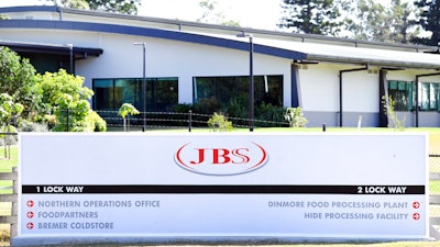 In this May 12, 2020 photo, the company logo sign sits at the entrance to the JBS Australia's Dinmore meatworks facility, west of Brisbane.