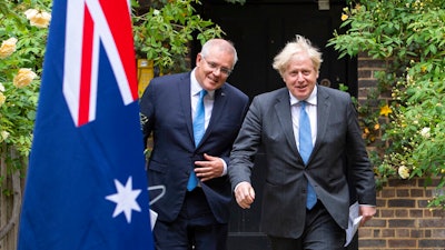 Britain's Prime Minister Boris Johnson, right, walks with Australian Prime Minister Scott Morrison after their meeting, in the garden of 10 Downing Streeet, in London on Tuesday June 15.