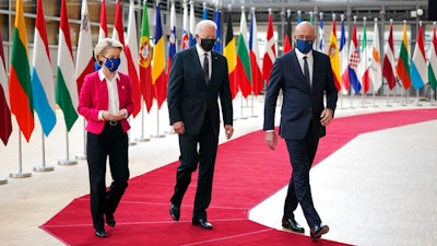 President Joe Biden, center, walks with European Council President Charles Michel, right, and European Commission President Ursula von der Leyen during the United States-European Union Summit at the European Council in Brussels, Tuesday, June 15, 2021.