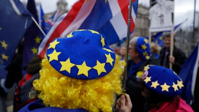 In this file photo dated Jan. 8, 2020, pro-Europe protesters demonstrate against Britain's Brexit split from the Bloc, outside the Houses of Parliament in London.