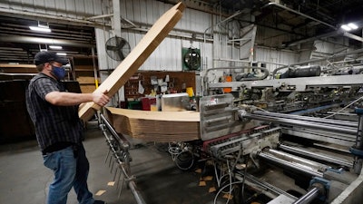 Rob Bondurant, a supervisor at Great Southern Industries, a packaging company, loads up a finishing machine in the Jackson, Miss., facility, Friday, May 28, 2021. The lack of workers has forced some supervisors to assume additional duties. Charita McCarrol, human resources manager at the company, cites the abuse by some people of the $300-a-week federal supplement for people who lost their jobs during the COVID-19 pandemic, as well as other programs that offered extended support for the unemployed, with providing a soon to end financial staple. She also cited that for some people, a steady paycheck and benefits like health care, are not enough of an incentive to pass up the expiring benefits.