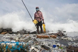 Sri Lankan man, Kindston Jayalath fishes on a polluted beach filled with plastic pellets washed ashore from the fire-damaged container ship MV X-Press Pearl in Kapungoda, on the out skirts of Colombo, Sri Lanka, Friday, June 4, 2021. Authorities were trying to head off a potential environmental disaster as the Singapore flagged ship that had been carrying chemicals was sinking off of the country's main port.